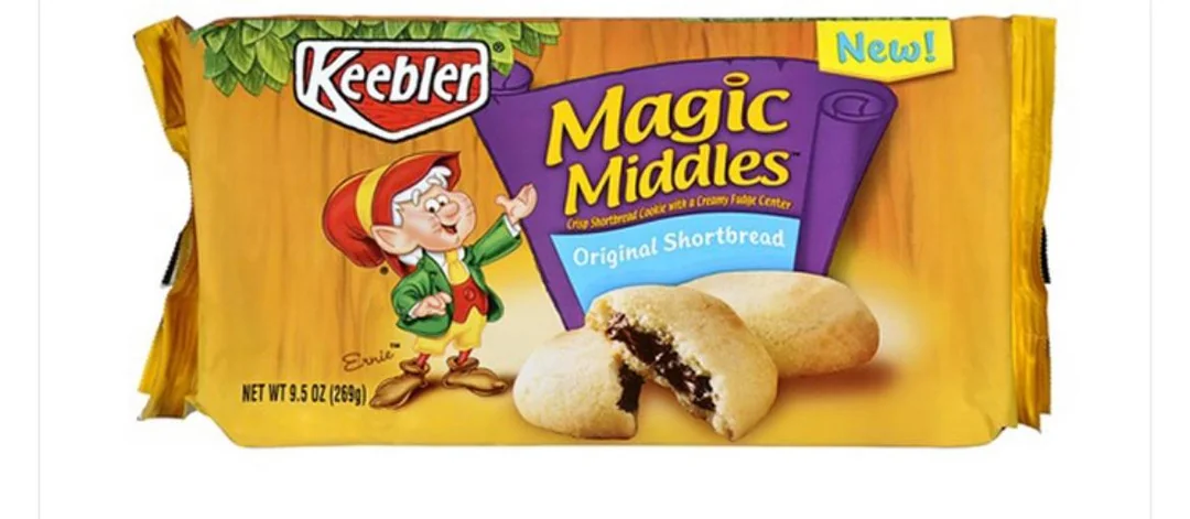 Package of Keebler Magic Middles Original Shortbread cookies, featuring an illustration of an elf and two cookies—one whole and one split open to show the chocolate fudge center. The package is yellow and purple with “New!” in the corner.