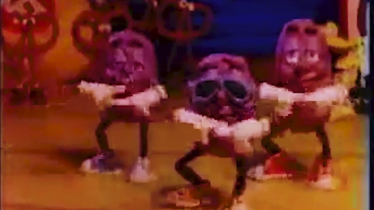 Three animated raisins with arms, legs, and sunglasses are dancing together against a colorful background. The raisins have expressive faces and are mid-dance, with arms outstretched.
