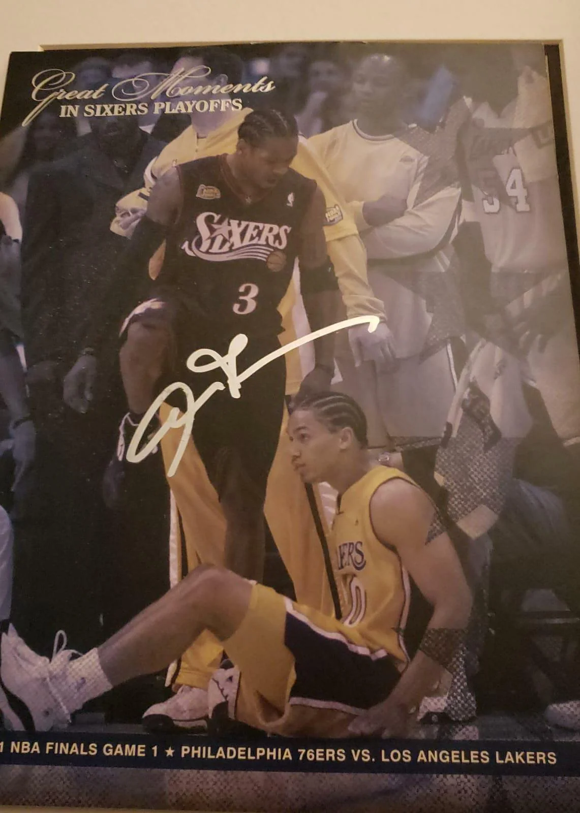 A signed photo shows Allen Iverson of the Philadelphia 76ers stepping over Tyronn Lue of the Los Angeles Lakers during the 2001 NBA Finals, with the caption “Great Moments in Sixers Playoffs” at the top.