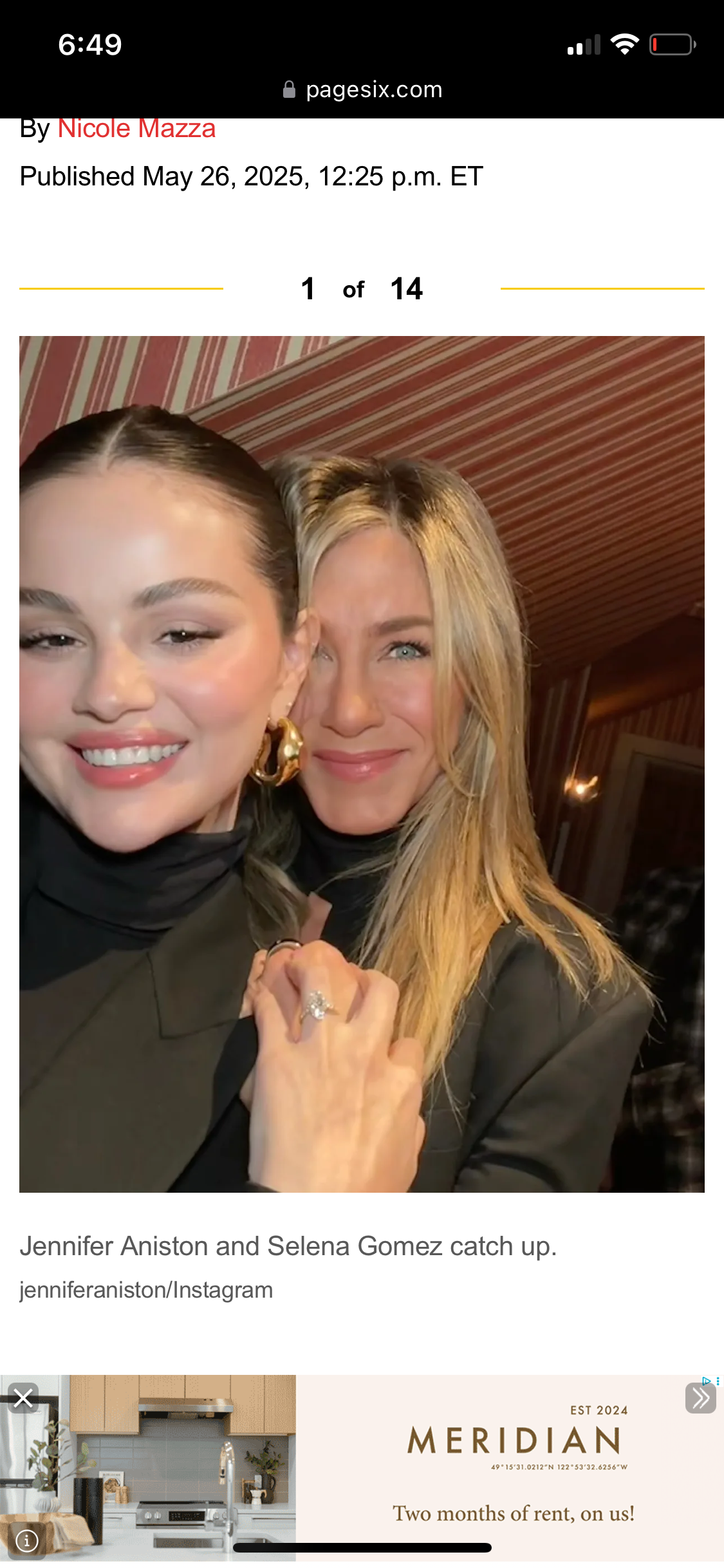 Selena Gomez and Jennifer Aniston smile closely together for a selfie, standing in a warmly lit room with red and white striped walls.