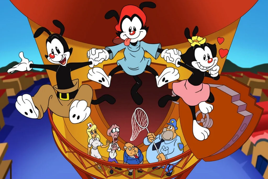 Three cartoon characters, two males and one female, leap joyfully from a tall tower, holding hands. Several other animated characters stand below them, looking up in surprise or concern. The scene is colorful and energetic.