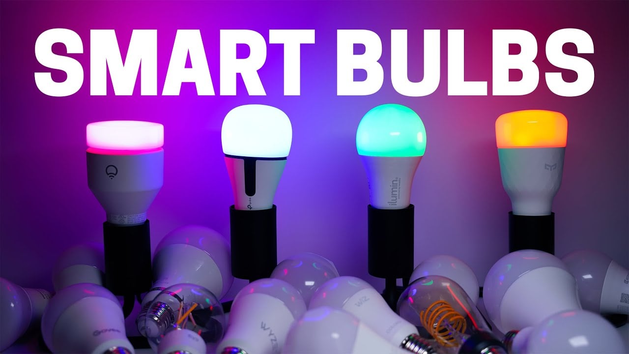 Four smart light bulbs in sockets emit different colors of light (pink, blue, green, orange) against a purple background. The words "SMART BULBS" appear above, with more bulbs scattered at the base.