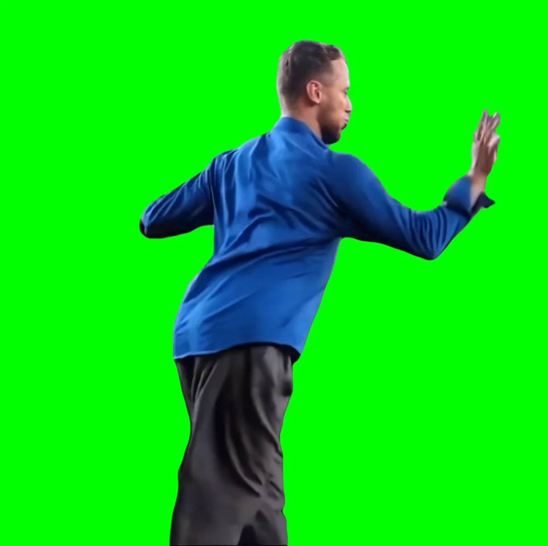 A person wearing a blue shirt and black pants is posing with one arm raised and bent, standing against a solid green background. The individual is facing sideways with their back partially towards the viewer.