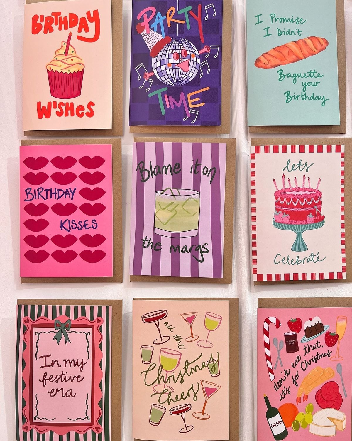 Nine colorful greeting cards are displayed in a 3x3 grid, each with festive illustrations and text celebrating birthdays, parties, cocktails, and Christmas, featuring cakes, drinks, hearts, and cheerful designs.