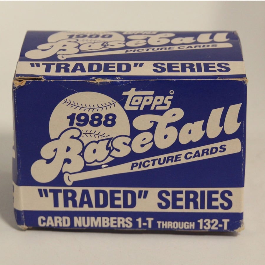 A blue and white box labeled "Topps 1988 Baseball Picture Cards 'Traded' Series" containing card numbers 1-T through 132-T. The box is slightly worn on the edges.