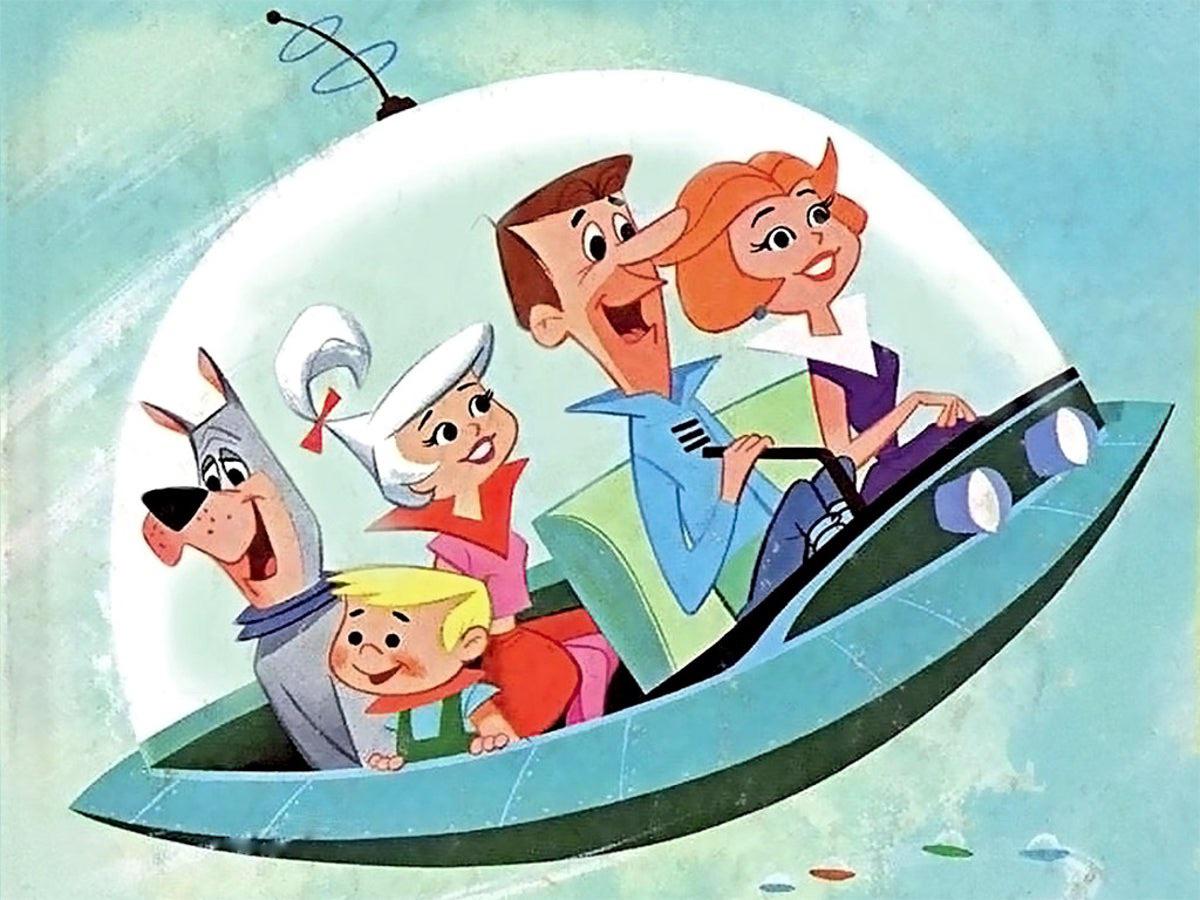 Animated family, including a dog, sits smiling inside a flying saucer-shaped car with a glass dome, set against a light blue background. The scene is colorful and retro-futuristic in style.