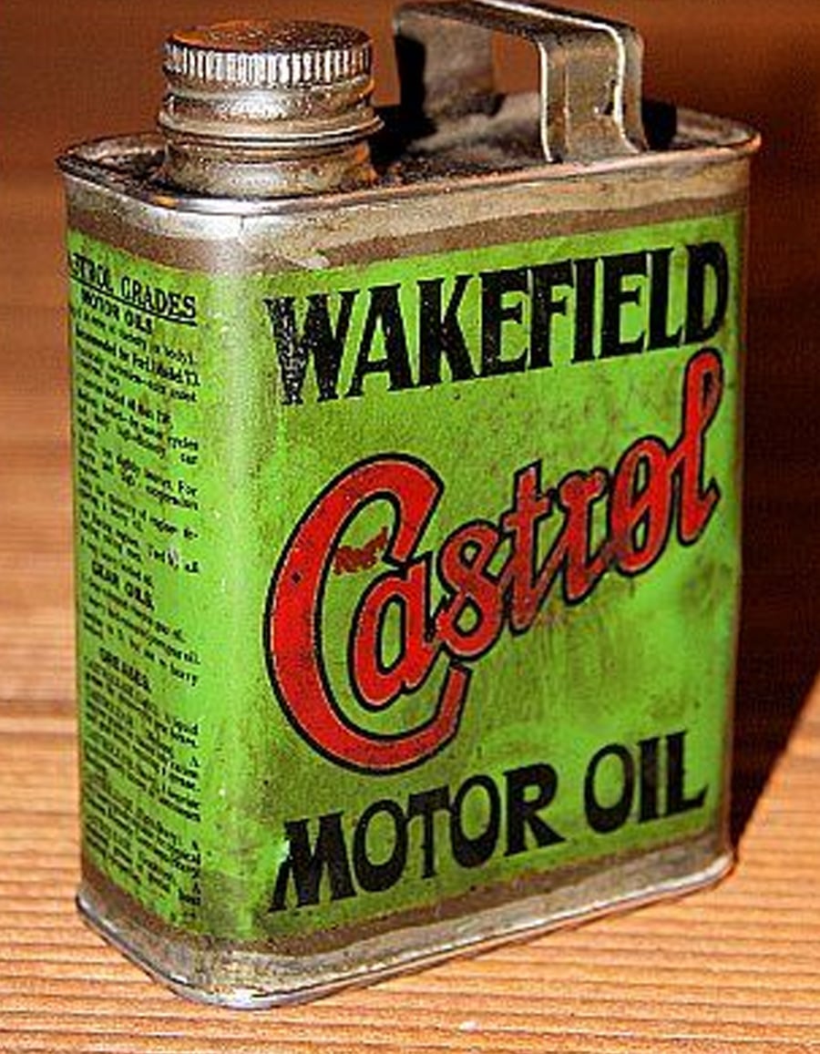 A vintage rectangular metal can of Wakefield Castrol Motor Oil with a screw cap, green body, and bold black and red lettering on the front.