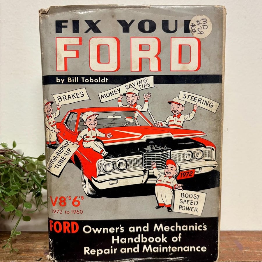 Cover of a book titled "Fix Your Ford" by Bill Toboldt, featuring cartoon mechanics pointing to parts of a red 1972 Ford car with text like "Brakes," "Money Saving Tips," and "Steering.