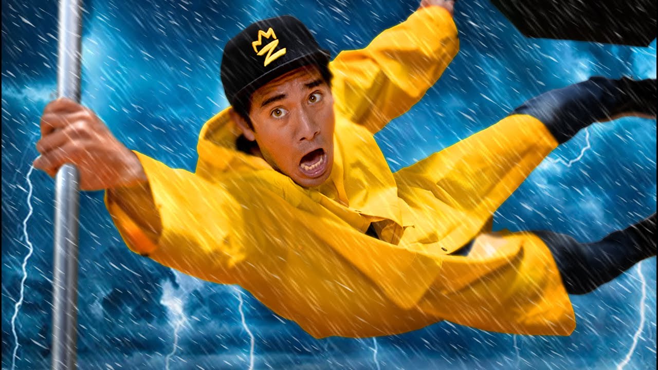 A man in a yellow raincoat and black cap clings to a pole, struggling against strong wind and heavy rain in a lightning storm, with a surprised expression on his face.