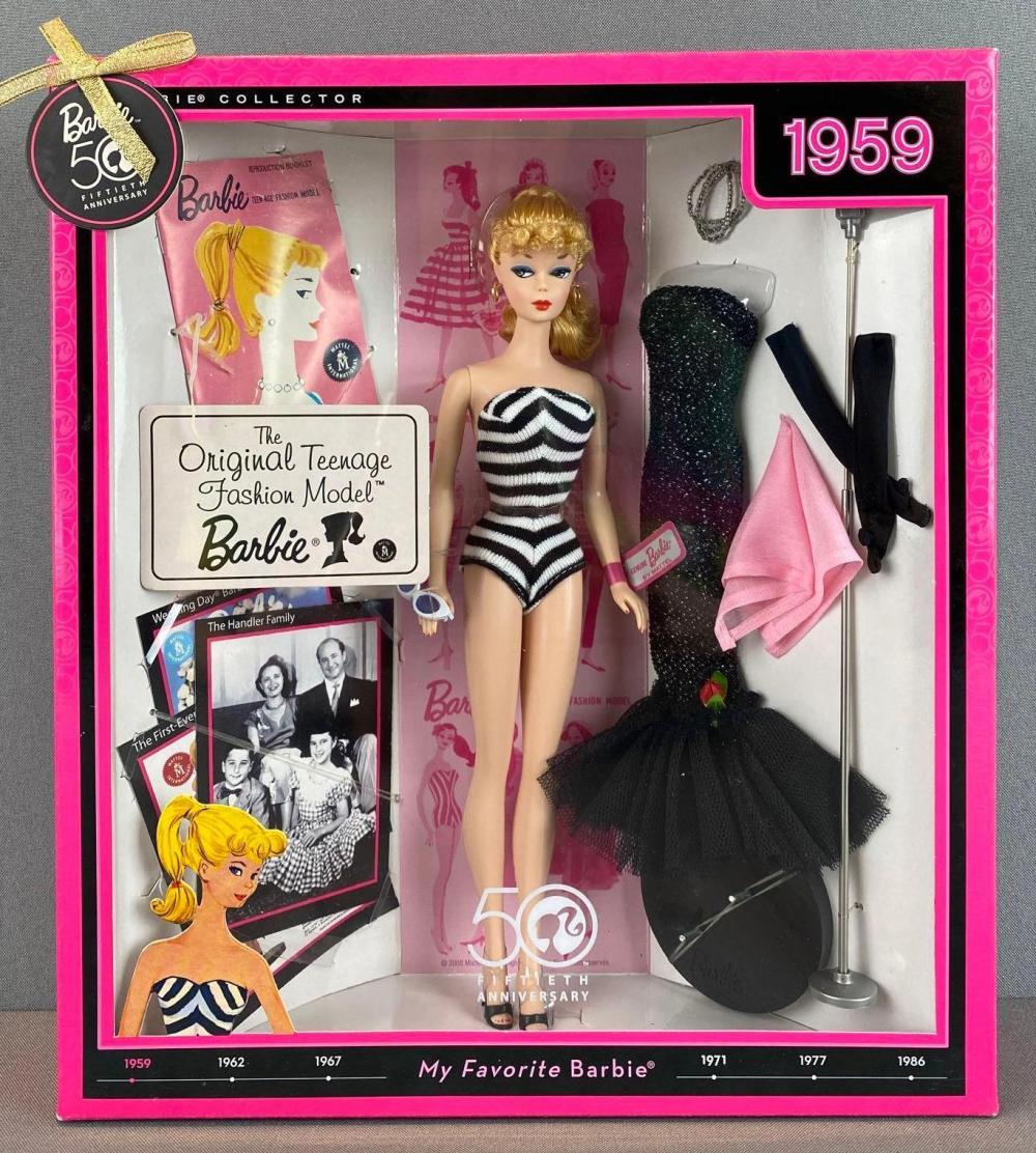 Barbie 50th Anniversary collector’s box featuring a 1959 Barbie doll in a black-and-white striped swimsuit, with accessories, outfits, and memorabilia, set against a pink background with 1959 highlighted in the corner.