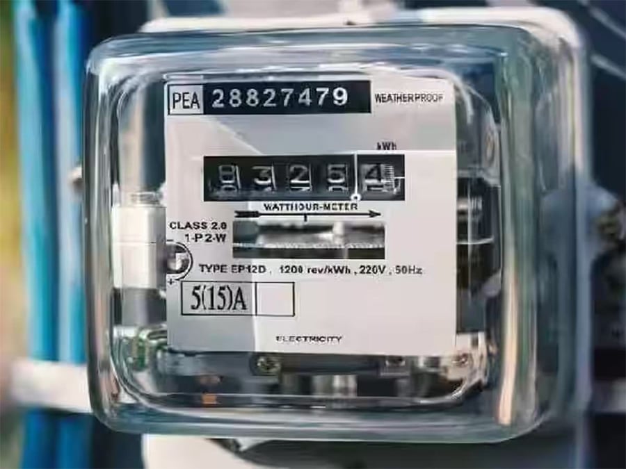 A close-up of an analog electricity meter with a transparent cover, black dials showing 83254 kWh, and labels indicating voltage, type, and other technical specifications.