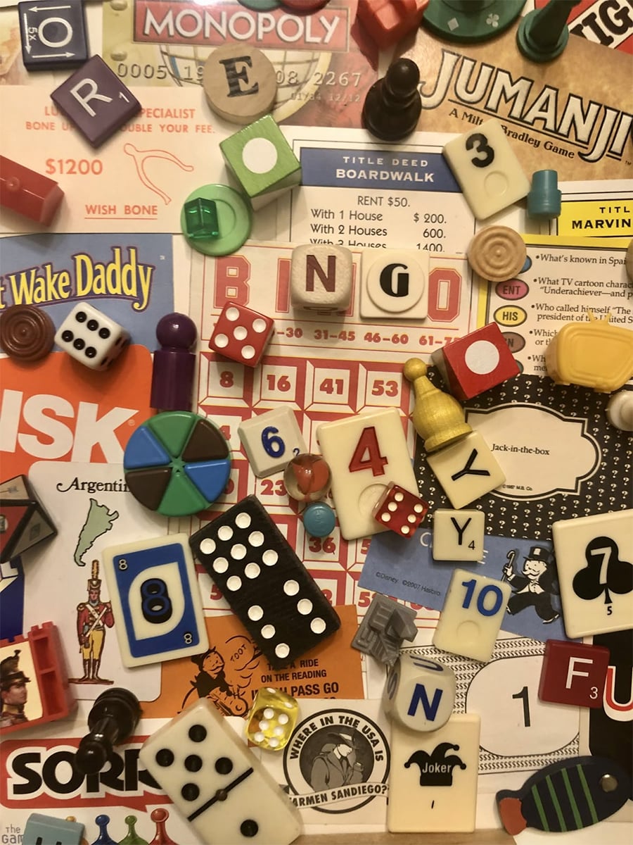 A colorful collage of various board game pieces, tiles, dice, cards, and tokens scattered over game boards from Monopoly, Jumanji, Risk, and more, creating a playful and nostalgic scene.