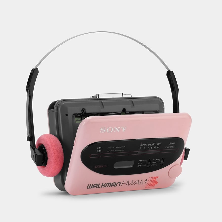 A pink Sony Walkman cassette player with attached gray headphones that have pink foam ear pads, set against a plain white background.