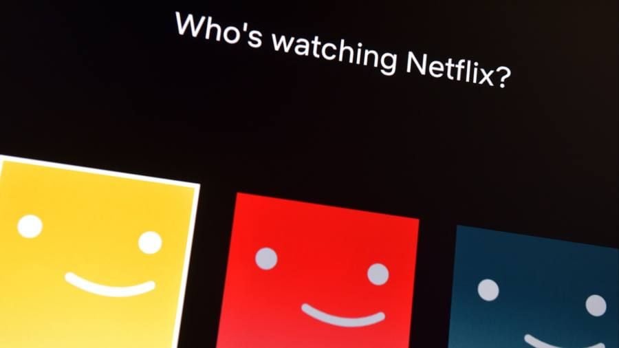 A Netflix screen displays "Who's watching Netflix?" above three colorful profile icons: yellow, red, and blue, each featuring a simple smiling face.