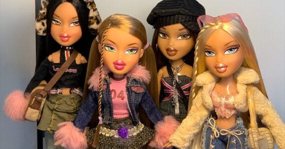 Four fashion dolls with long hair, bold makeup, and trendy outfits featuring faux fur, denim, and accessories, stand together against a neutral background, posing stylishly for the camera.
