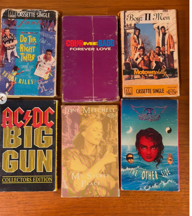 Six cassette singles are arranged on a wooden surface. Titles include: Do the Right Thing, Forever Love, Motownphilly, Big Gun, My Secret Place, and The Other Side, each with unique cover art.