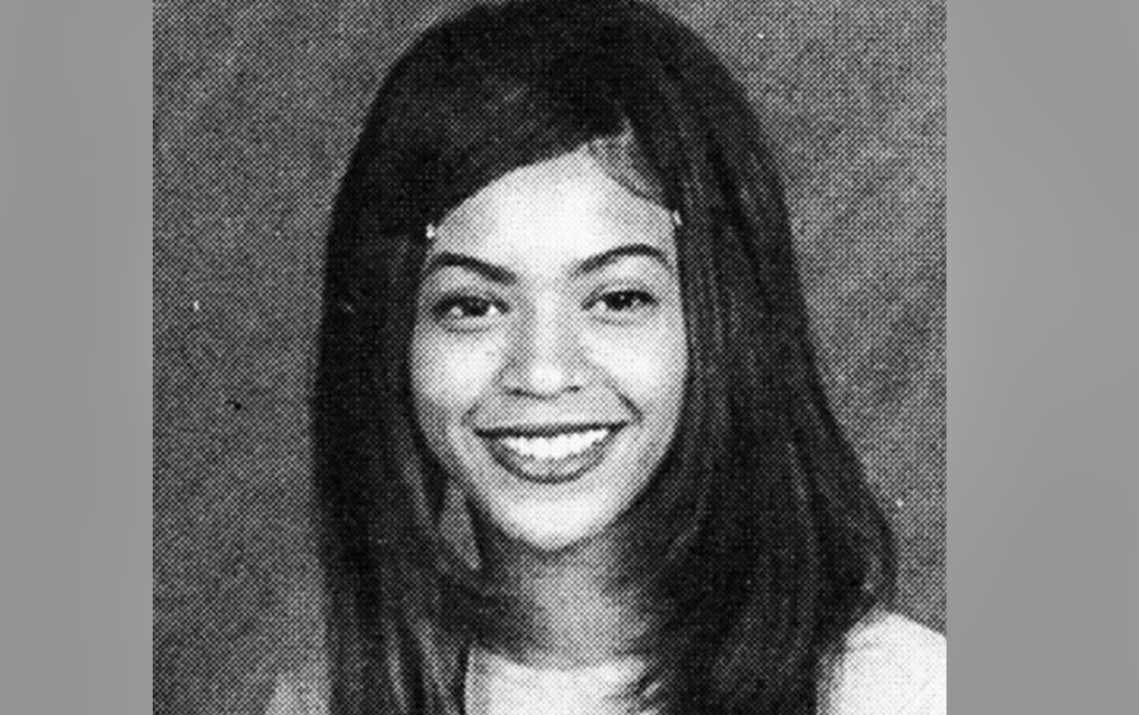 A black-and-white yearbook-style portrait of a young woman with straight, shoulder-length hair, smiling and looking at the camera, set against a plain background.
