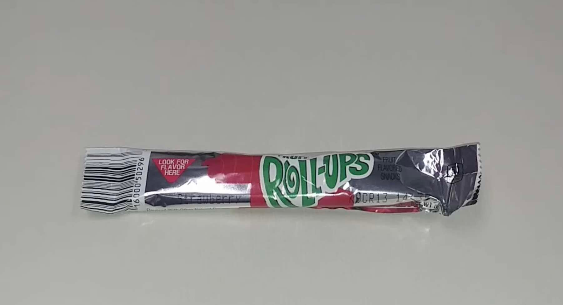 A single unopened Fruit Roll-Ups package, silver with green and red text, is placed on a plain white surface.
