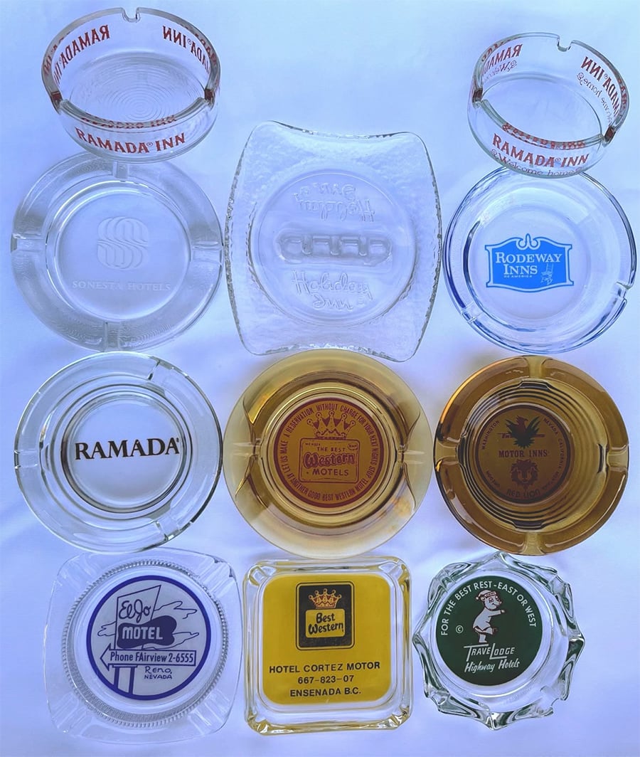 Nine vintage glass ashtrays from various hotels and motels are arranged in a 3x3 grid, each displaying unique logos and designs, including Ramada, Rodeway Inn, and Town House Motel.
