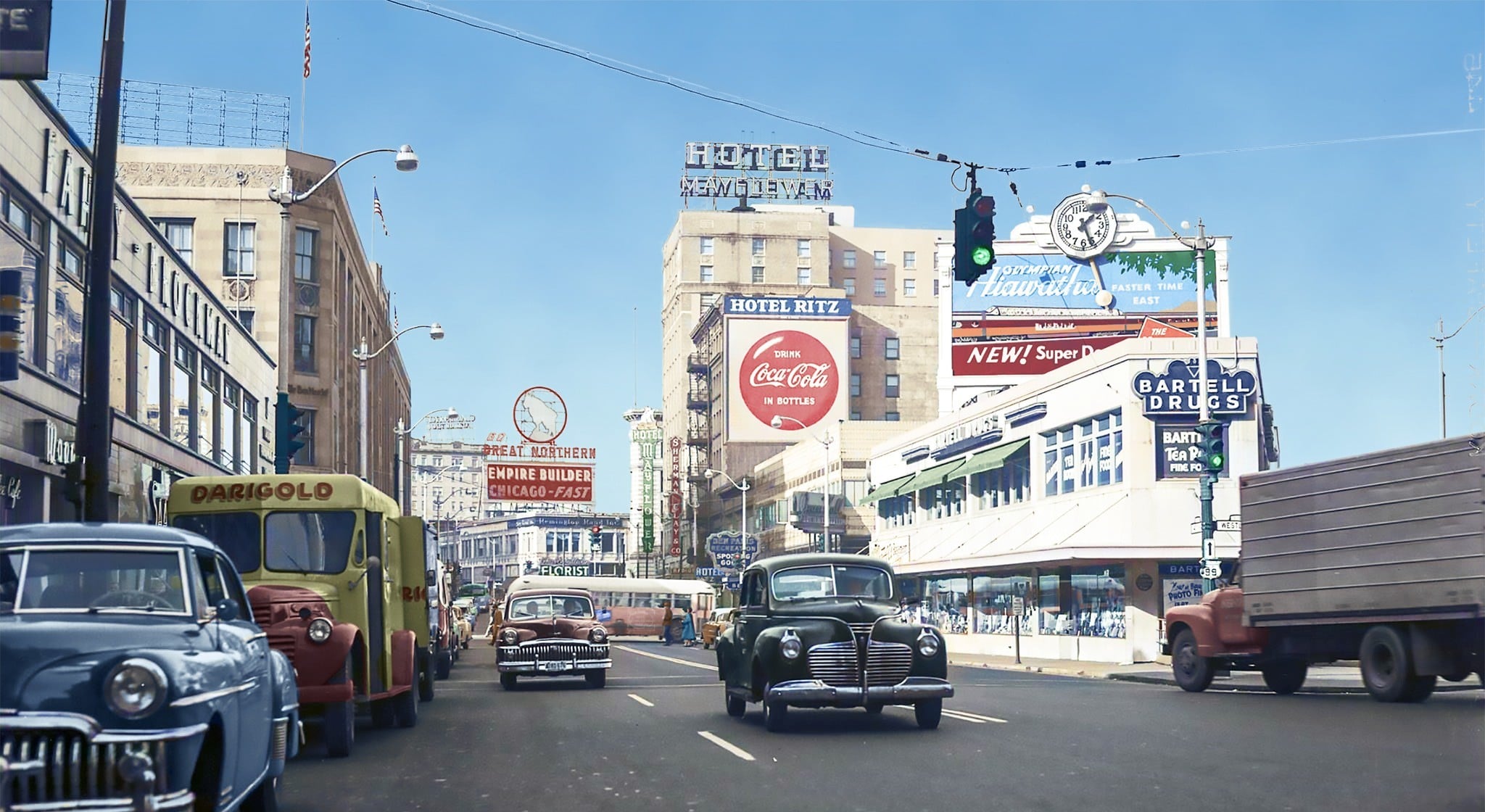 A busy city street scene from the mid-20th century featuring vintage cars, delivery trucks, pedestrians, and storefronts with large signs and advertisements, including a prominent Coca-Cola billboard.