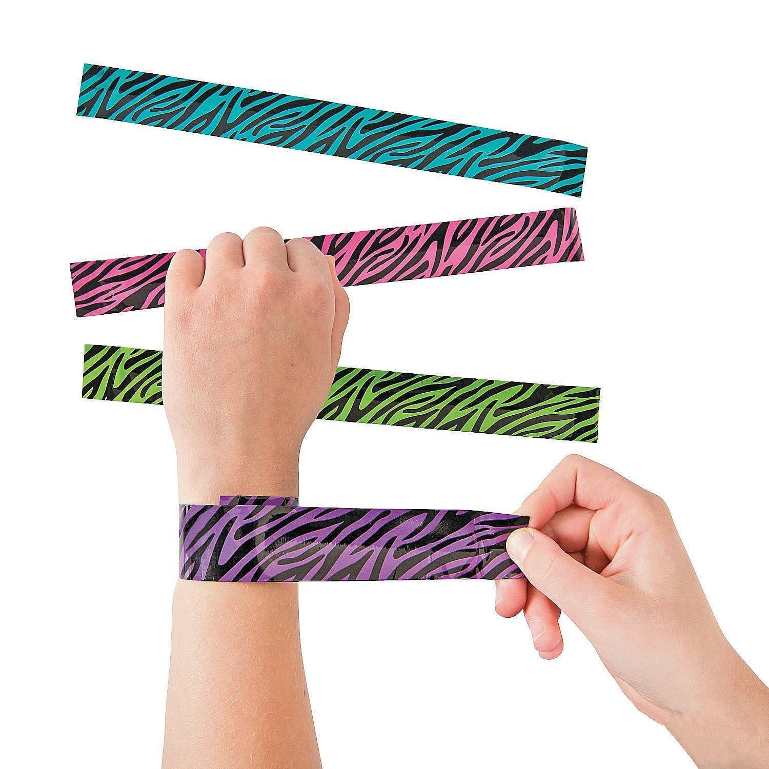 A hand wraps a purple zebra-print slap bracelet around their wrist. Three more slap bracelets in blue, pink, and green zebra patterns are displayed above on a white background.