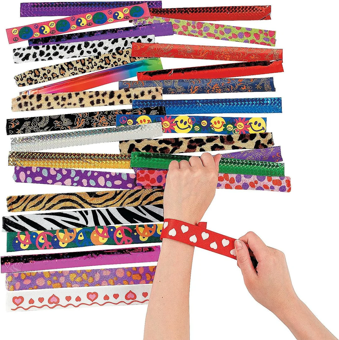 A variety of colorful slap bracelets with different patterns, such as animal prints, hearts, and smiley faces. A hand is shown slapping a red bracelet with white hearts onto the wrist.
