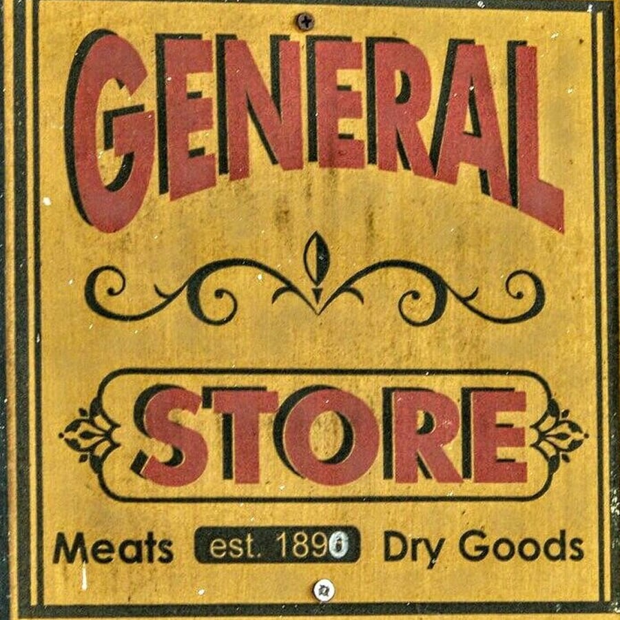 A vintage sign reads: "GENERAL STORE, Meats, Dry Goods, est. 1890" with decorative accents on a yellow background.