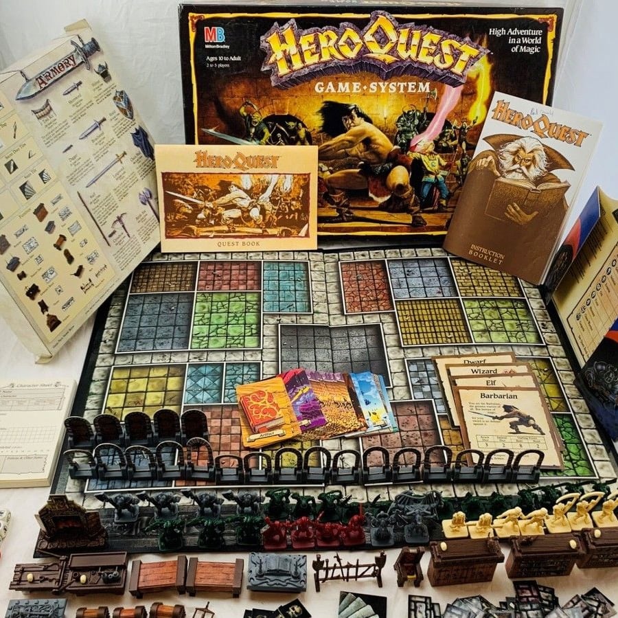 HeroQuest board game set up with game board, box, cards, books, figurines, dice, and various playing pieces arranged neatly, showcasing the full contents of the classic fantasy adventure board game.