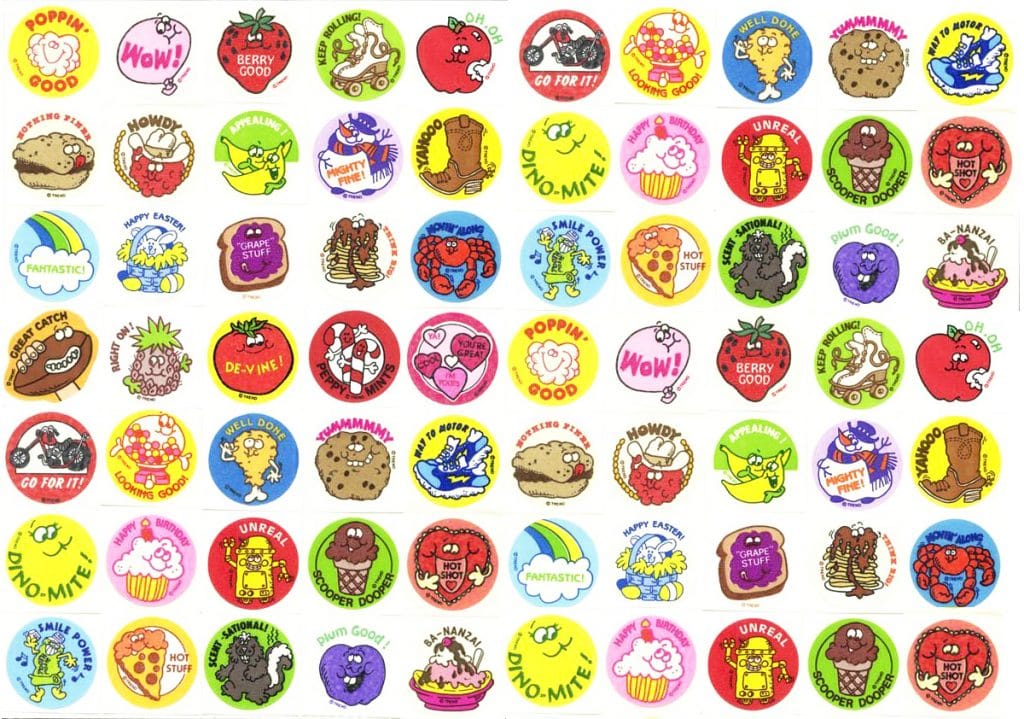 A colorful sheet of round stickers featuring cartoon foods, animals, and encouraging phrases like “Fantastic,” “Berry Good,” “Go For It!” and “Wow!” arranged in a grid pattern.
