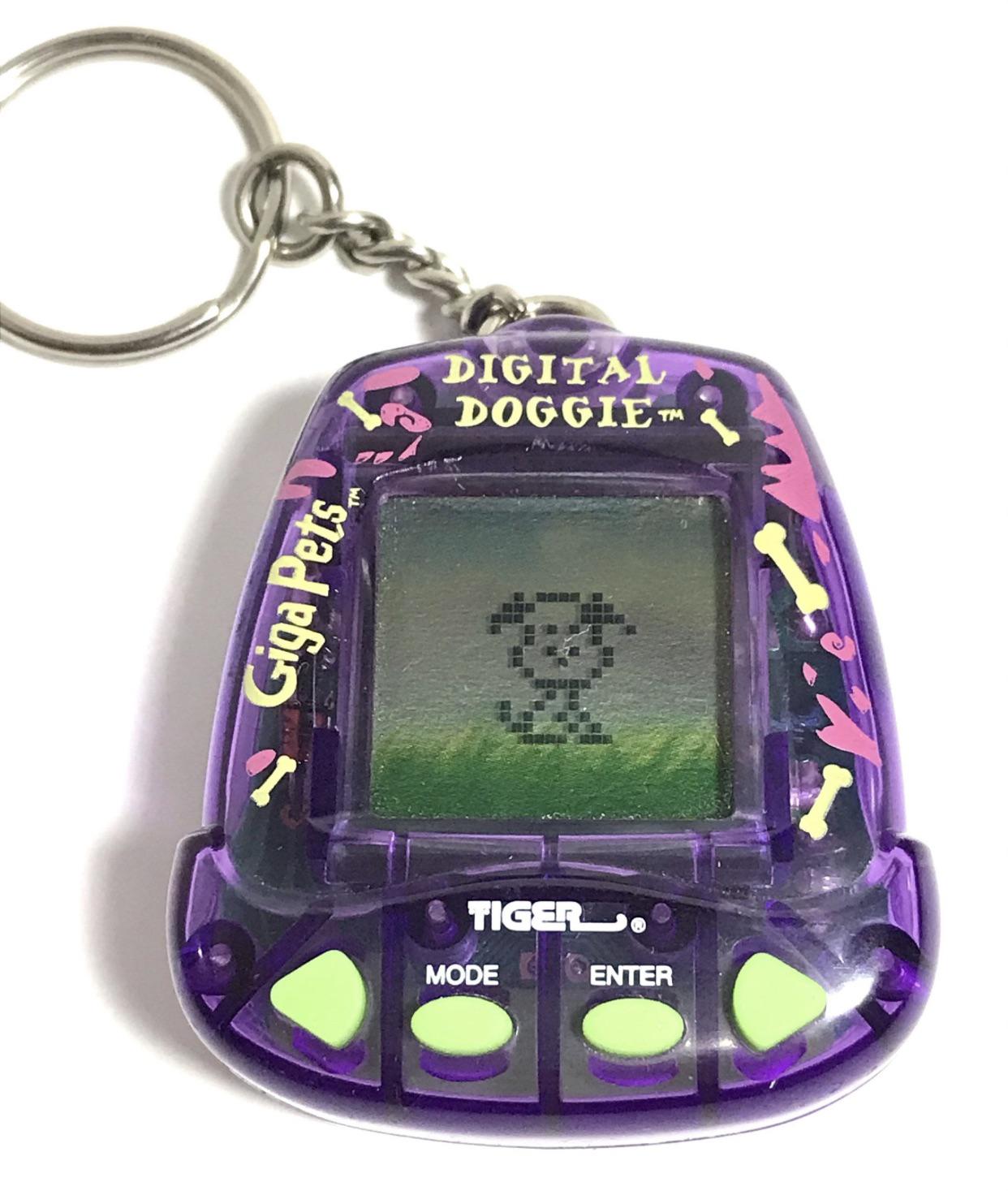 A purple Digital Doggie Giga Pets keychain toy with a small pixelated dog displayed on its screen and green buttons below the screen.