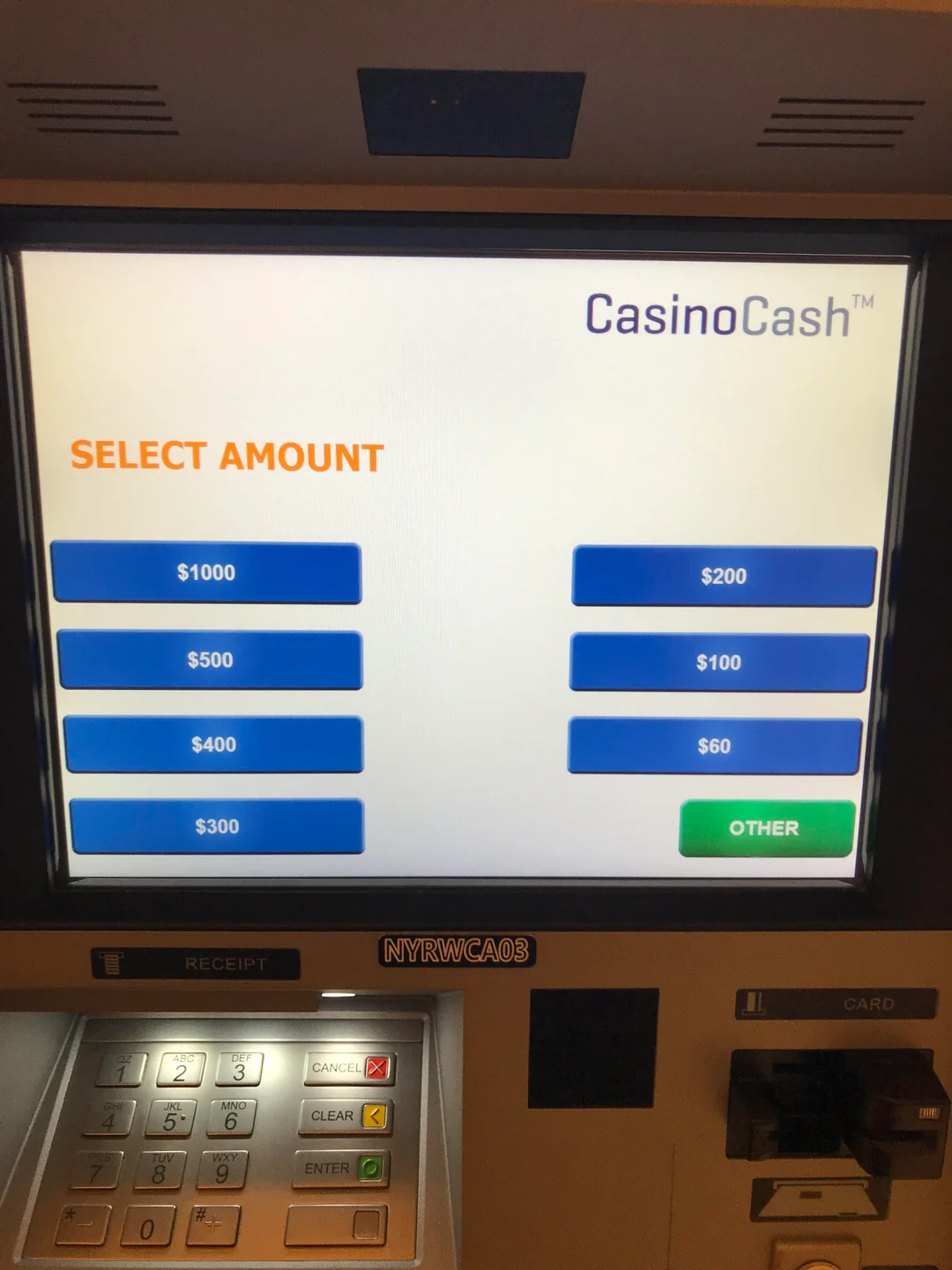 ATM screen displaying "CasinoCash" with options to select amounts: $1000, $500, $400, $300, $200, $100, $60, and a green "Other" button. Keypad and card slot are visible below the screen.
