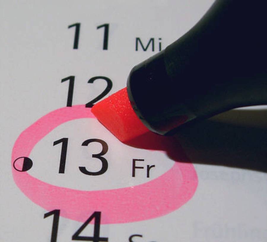 A pink marker circles Friday the 13th on a calendar, highlighting the date.