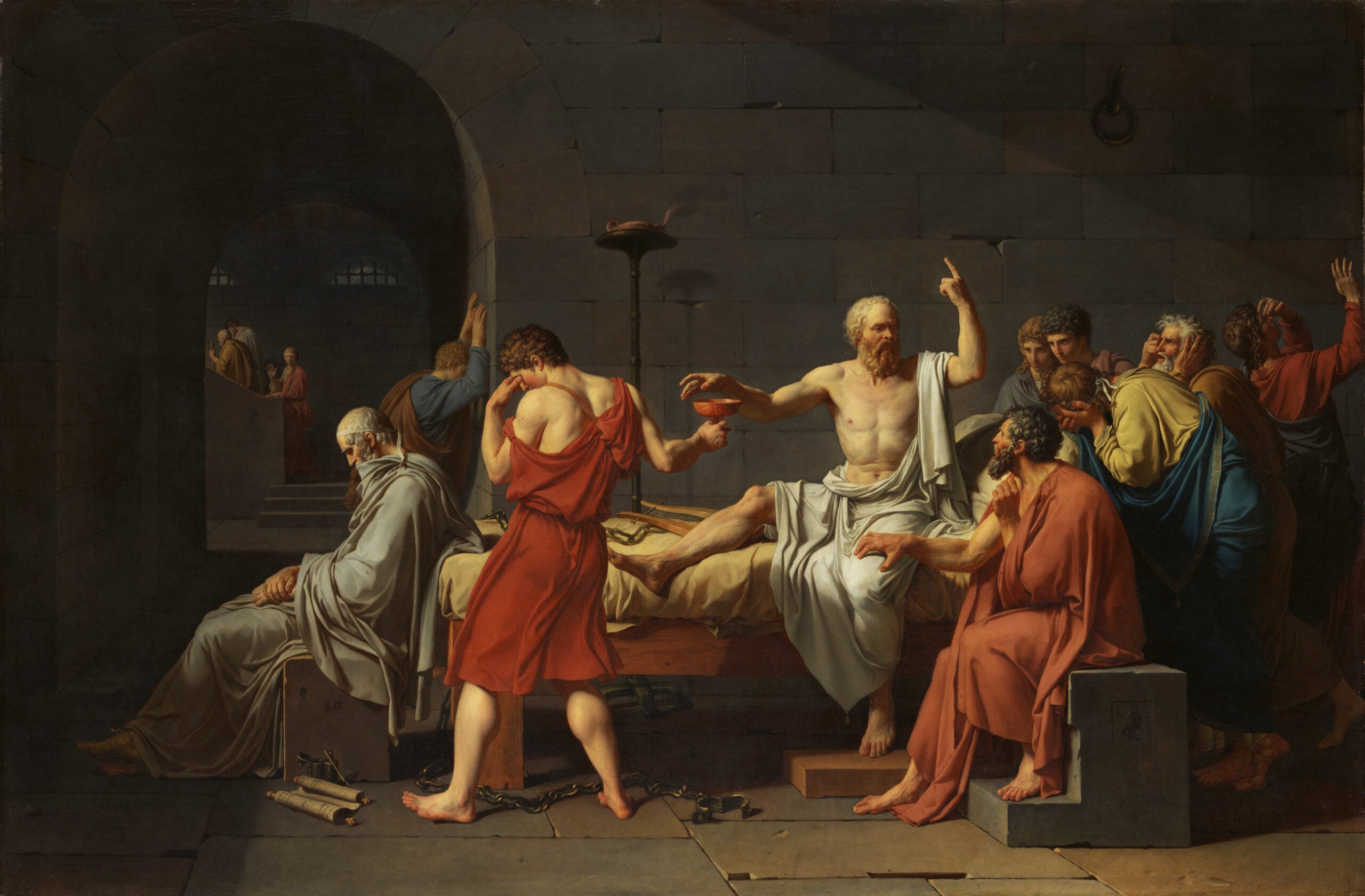 A man sits on a bed, surrounded by followers, gesturing upward as another hands him a cup. The scene is dramatic, set in a dim stone cell, with emotional figures displaying grief and despair.