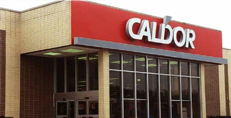 The entrance of a Caldor store with large glass windows and a red sign displaying the Caldor logo above the doors.