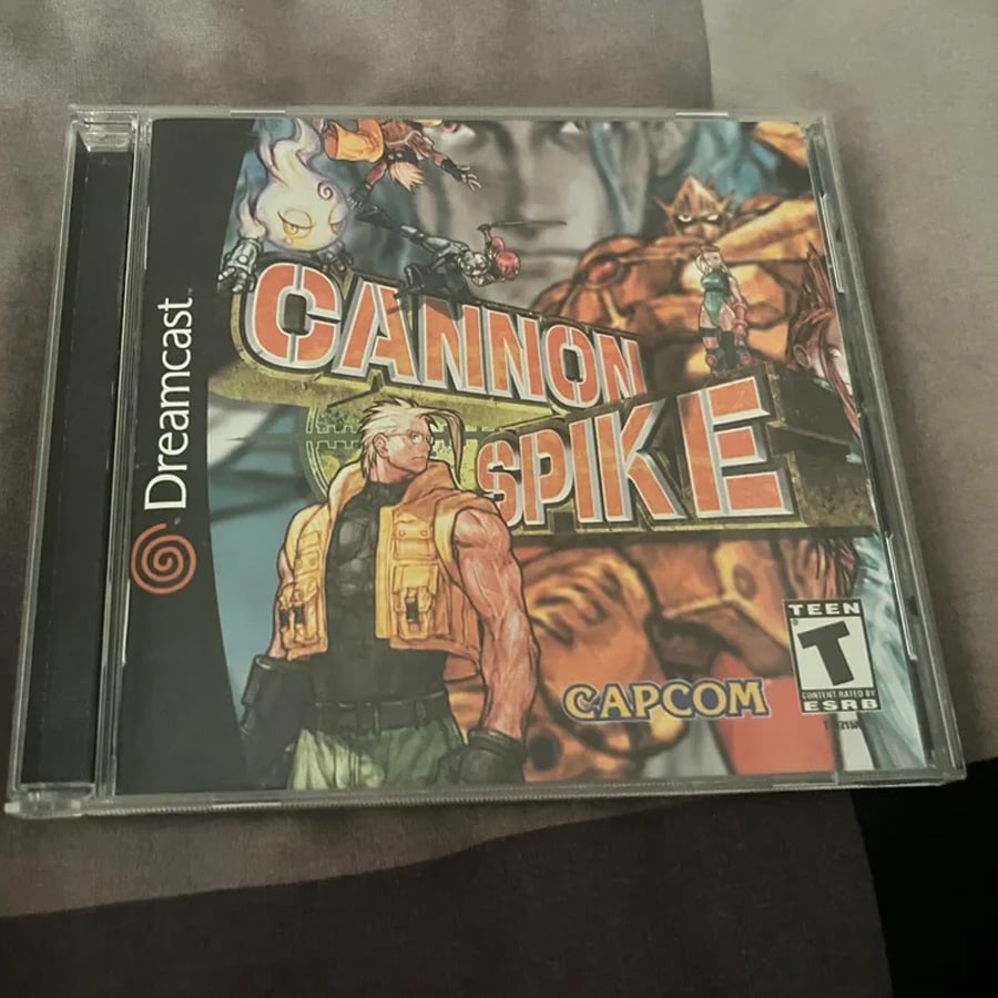 A Sega Dreamcast game case for “Cannon Spike” by Capcom, featuring illustrated action characters on the cover and a T for Teen rating in the bottom right corner.