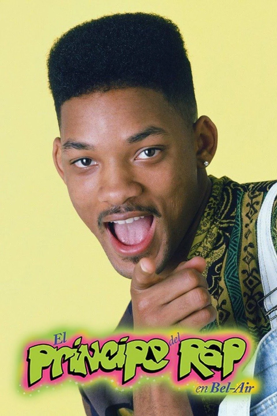 A young man with a flat-top haircut smiles and points at the camera. The colorful text “El Príncipe del Rap en Bel-Air” appears at the bottom. The background is bright yellow.