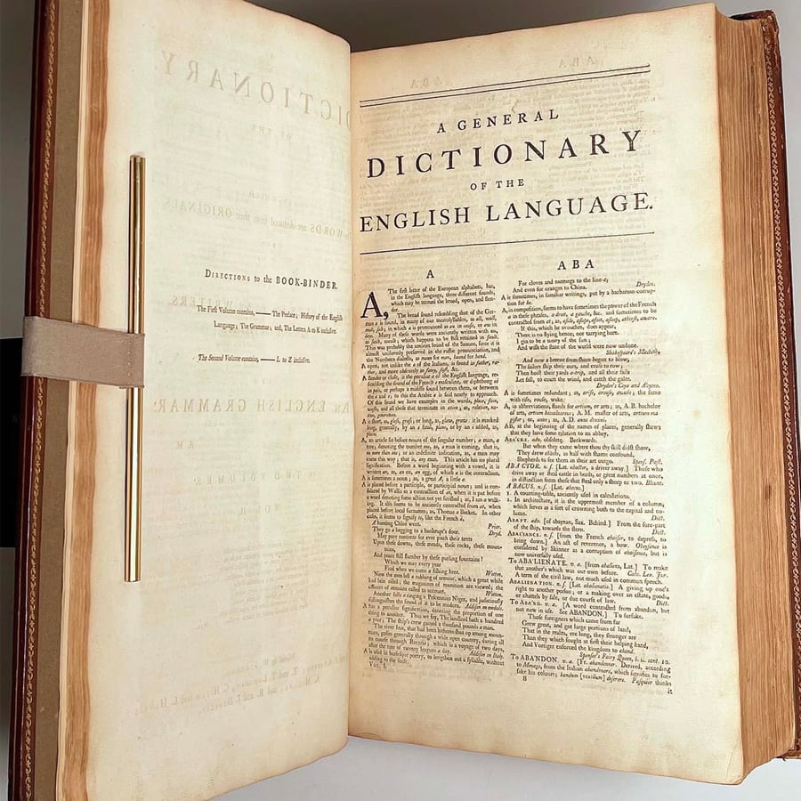 An open antique book shows the title “A General Dictionary of the English Language.” The first page of entries under the letter A is visible, with aged, yellowed pages and clear, classic typesetting.