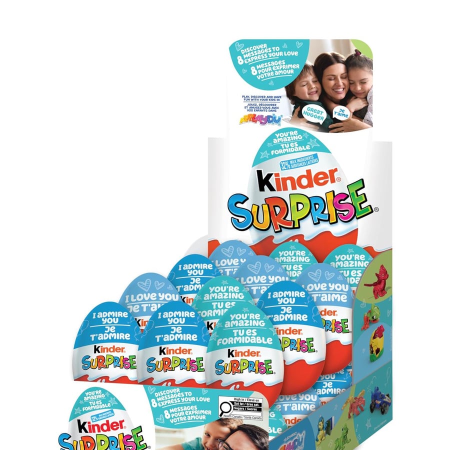 A display of Kinder Surprise chocolate eggs featuring messages like “I admire you” and “You’re amazing,” with images of happy children on the top panel.