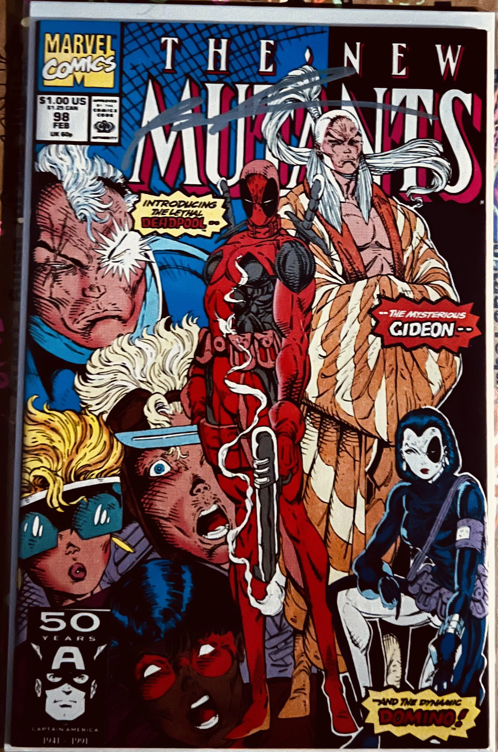Comic book cover: “The New Mutants #98” features Deadpool, Gideon, and Domino in action poses, with dramatic facial expressions and dynamic graphics. The Marvel Comics logo is in the top left corner.