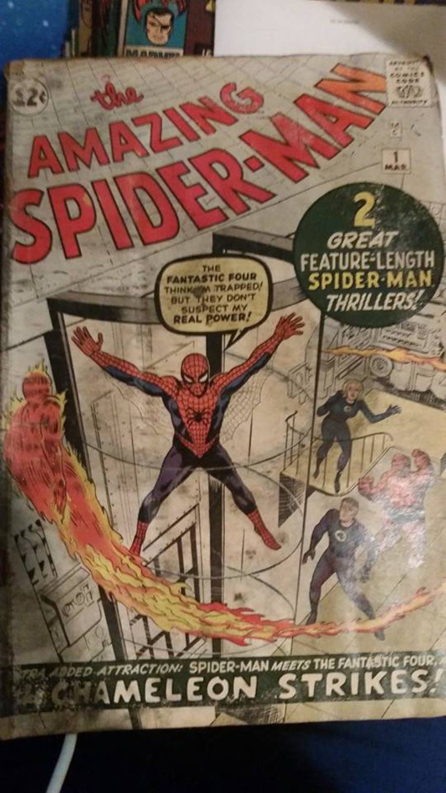 A vintage “Amazing Spider-Man” comic book cover shows Spider-Man swinging with the Fantastic Four watching. The cover advertises “2 great Spider-Man thrillers” and features “Chameleon Strikes!”
