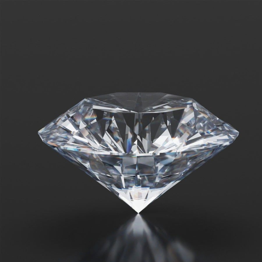 A sparkling, cut diamond with many facets sits on a reflective black surface, displaying brilliance and clarity.