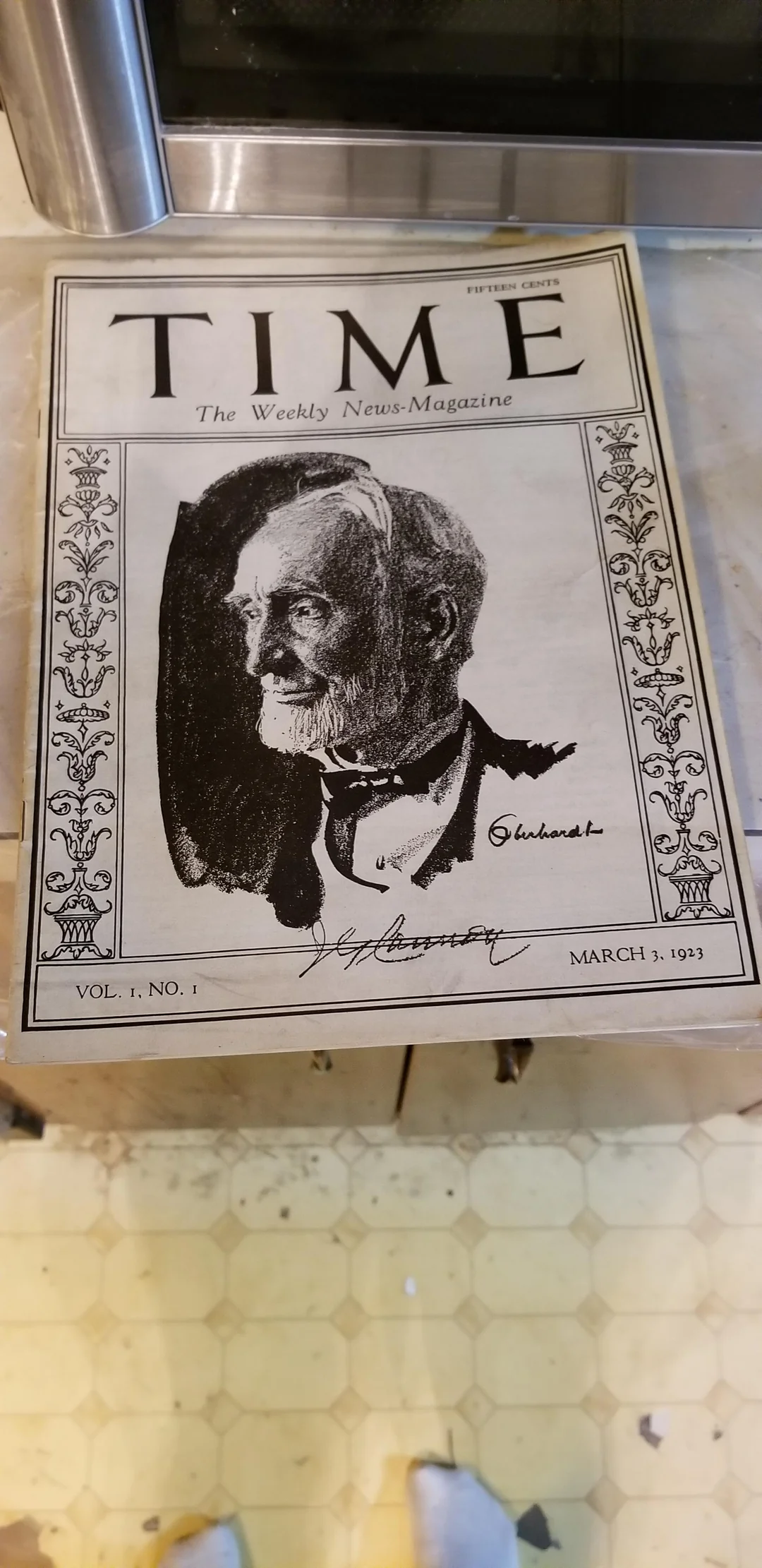 A vintage TIME magazine cover dated March 3, 1923, featuring a black and white sketch of a bearded man in a suit, with floral borders and signatures below the portrait.