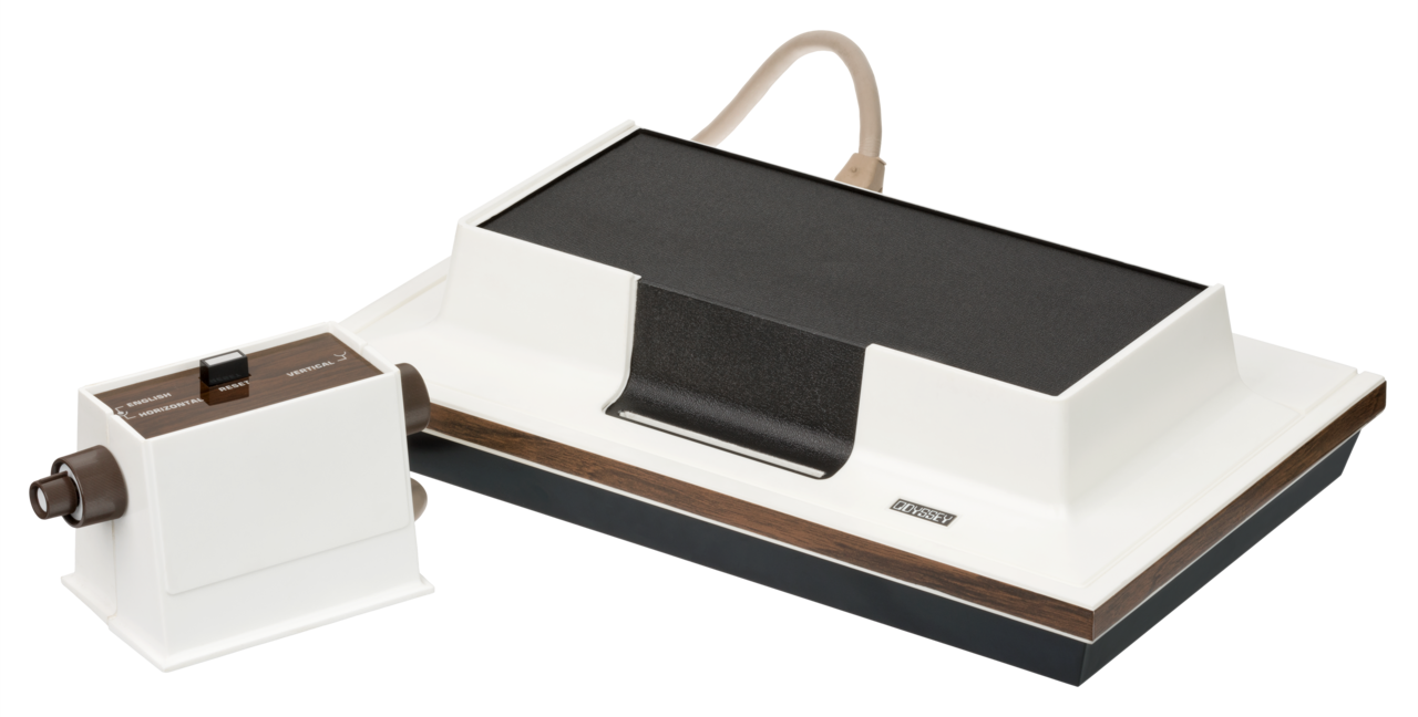 A vintage Magnavox Odyssey game console with a white and brown design, connected to a box-shaped controller with a brown knob, both on a plain white background.