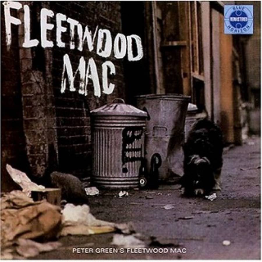 A dog sniffs near metal trash cans in an alleyway. The words “Fleetwood Mac” are written largely at the top. The image is the cover of Fleetwood Mac’s album “Peter Green’s Fleetwood Mac.”