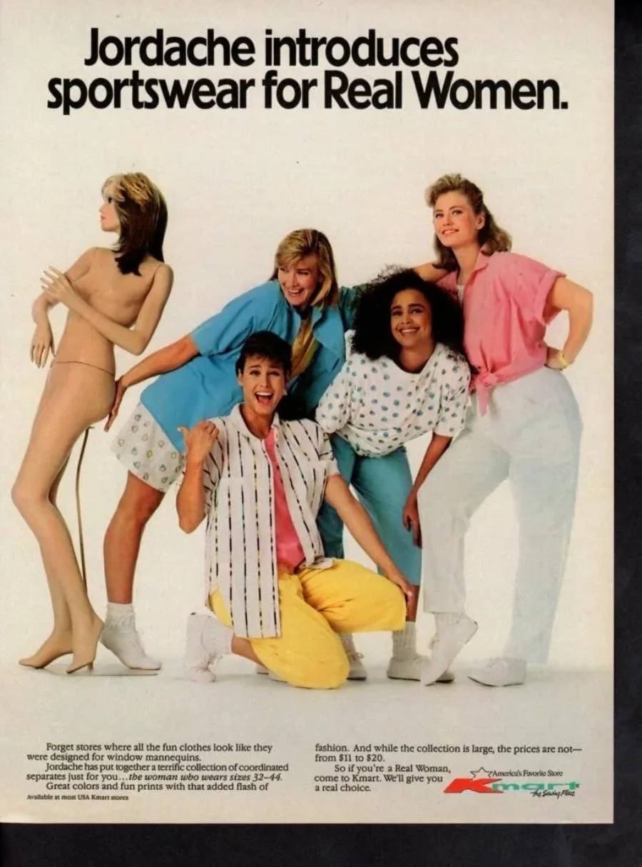 Four smiling women in colorful 1980s sportswear pose next to a mannequin. The text above them reads, “Jordache introduces sportswear for Real Women.”