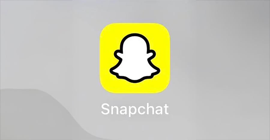 Snapchat app icon with a white ghost outlined in black on a yellow background, and the word “Snapchat” in white text below it.