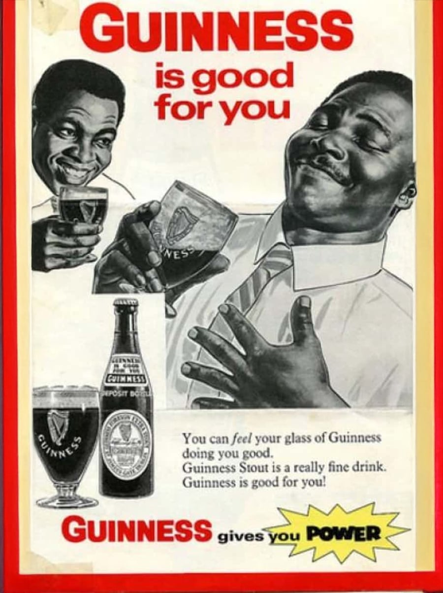 Vintage Guinness ad featuring two men enjoying Guinness, with one smiling and holding his chest. The text reads, “Guinness is good for you. Guinness gives you power,” alongside a bottle and glass of Guinness.