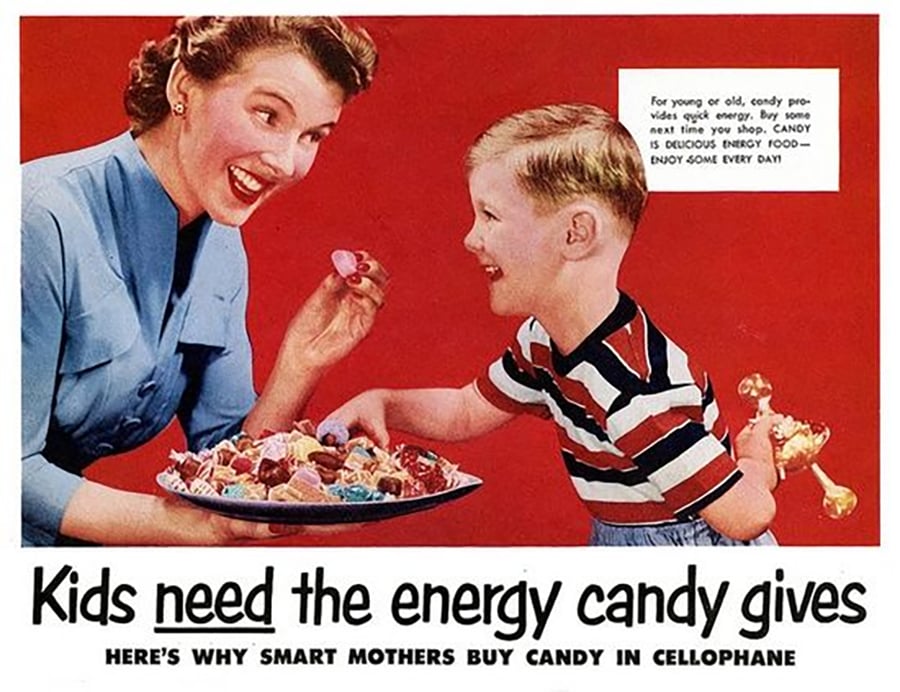 A woman offers a smiling boy a plate of colorful candy. Bold text reads, “Kids need the energy candy gives,” with a note describing candy as energy food. Both appear happy against a red background.
