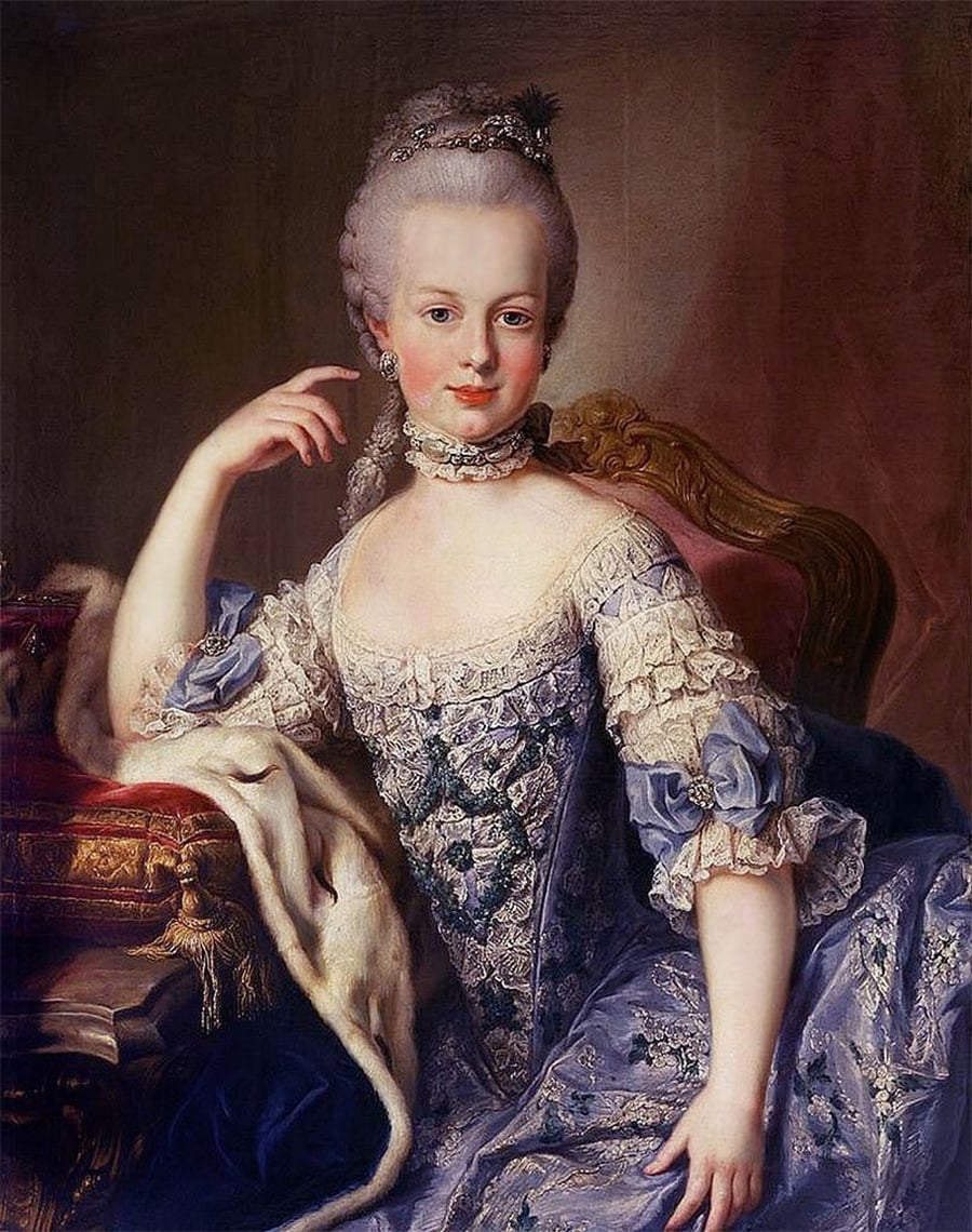 A woman in an elaborate blue and white 18th-century gown sits on a chair, with a fur draped over her arm, posing gracefully in a formal portrait setting.