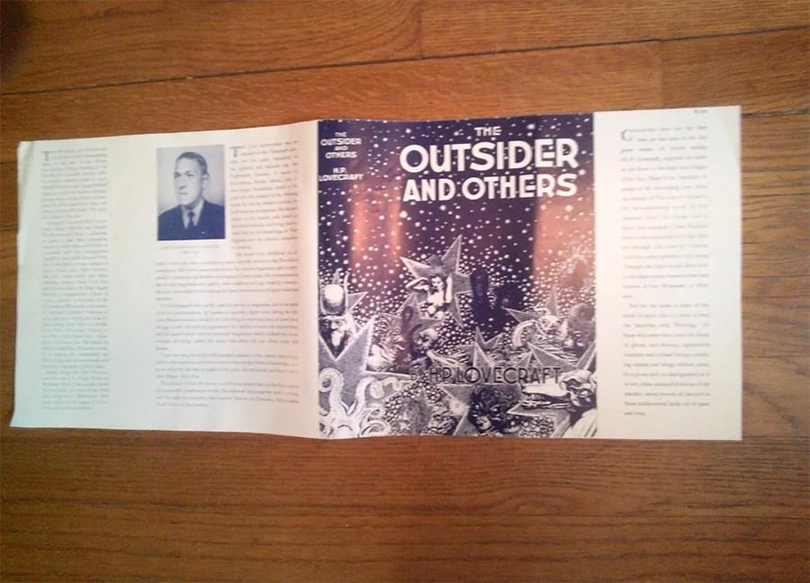 A book jacket for “The Outsider and Others” by H.P. Lovecraft, featuring an illustrated cover with strange creatures and snowy scenery, plus author info and a biography on the flaps.